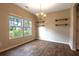 Bright dining area with modern light fixture, laminate flooring, and two windows letting in natural light at 408 Fox Sparrow Ct, Summerville, SC 29486