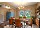 Dining room with a wooden table, leather chairs, modern light fixture, and natural light from the windows at 408 Fox Sparrow Ct, Summerville, SC 29486