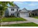 Charming two-story home with an attached two-car garage, well-manicured lawn, and lovely landscaping at 408 Fox Sparrow Ct, Summerville, SC 29486