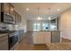 Open concept kitchen featuring modern appliances, granite countertops, tile backsplash, and laminate flooring at 408 Fox Sparrow Ct, Summerville, SC 29486