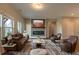 Cozy living room with a comfortable sofa, two armchairs, a fireplace, and a large television at 408 Fox Sparrow Ct, Summerville, SC 29486