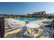 Community pool with lounge chairs and tables provides a relaxing space for residents and guests at 408 Fox Sparrow Ct, Summerville, SC 29486
