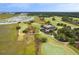 Gorgeous aerial view of waterfront property with golf course, dock, and surrounding marshland at 4121 Golf Cottage Ln, Johns Island, SC 29455