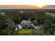 Expansive property boasting a luxury home, pool, and lush greenery against a scenic backdrop at 4121 Golf Cottage Ln, Johns Island, SC 29455
