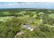 Aerial view of property surrounded by lush trees; home has pool and is located near a golf course at 4121 Golf Cottage Ln, Johns Island, SC 29455