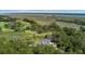 Scenic aerial view of property, a golf course, river, and marshland with lush greenery and trees surrounding the landscape at 4121 Golf Cottage Ln, Johns Island, SC 29455