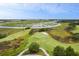 Stunning aerial view of a golf course and marshland landscape with winding waterways and pristine scenery at 4121 Golf Cottage Ln, Johns Island, SC 29455