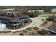 Aerial view showcases a large building with multiple levels and patios, next to a manicured golf course at 4121 Golf Cottage Ln, Johns Island, SC 29455