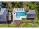 Aerial view of a backyard oasis with pool, outdoor kitchen, and beautifully landscaped greenery at 4121 Golf Cottage Ln, Johns Island, SC 29455