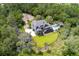 Aerial view showcasing home nestled among lush greenery, pool and outdoor living, and winding driveway at 4121 Golf Cottage Ln, Johns Island, SC 29455