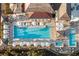 Aerial view of the pool, including lounge chairs, umbrellas and lush landscaping at 4121 Golf Cottage Ln, Johns Island, SC 29455
