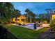 Luxurious backyard oasis with a sparkling pool, cabana, lounge chairs, and manicured landscaping at 4121 Golf Cottage Ln, Johns Island, SC 29455
