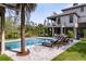 Beautiful backyard pool area with lounge chairs and a covered patio of a two-story home at 4121 Golf Cottage Ln, Johns Island, SC 29455