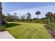 Expansive lawn in the backyard, perfect for outdoor activities and recreation with mature trees in the background at 4121 Golf Cottage Ln, Johns Island, SC 29455