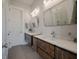 Modern bathroom with double sinks, stylish wood cabinets, white countertops, and decorative mirrors at 4121 Golf Cottage Ln, Johns Island, SC 29455
