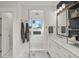 Bright bathroom featuring marble floors, a glass shower with a blue tiled inlay, and white cabinets at 4121 Golf Cottage Ln, Johns Island, SC 29455