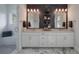 Elegant bathroom with double sinks, stylish mirrors, and decorative lighting at 4121 Golf Cottage Ln, Johns Island, SC 29455