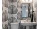 Bathroom featuring graphic wallpaper, pedestal sink, and black framed mirror at 4121 Golf Cottage Ln, Johns Island, SC 29455