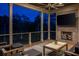 Cozy covered deck with a fireplace, TV, comfortable seating, and scenic views at 4121 Golf Cottage Ln, Johns Island, SC 29455