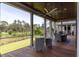 Relaxing covered deck with wood floors, ceiling fans and a view of the golf course at 4121 Golf Cottage Ln, Johns Island, SC 29455