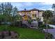 Exterior of home with front yard landscaping, a set of stairs leading to the front door, and palm trees in front at 4121 Golf Cottage Ln, Johns Island, SC 29455