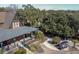 Beautiful craftsman-style home featuring a covered porch, mature trees, and brick driveway with golf cart at 4121 Golf Cottage Ln, Johns Island, SC 29455