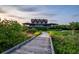 Stunning exterior view of a multi-story building with lush landscaping and boardwalk at 4121 Golf Cottage Ln, Johns Island, SC 29455