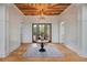 Elegant foyer featuring hardwood floors, a decorative ceiling, and a stylish table with floral arrangement at 4121 Golf Cottage Ln, Johns Island, SC 29455