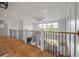 Open foyer with hardwood floors, black metal railings, and views to the downstairs at 4121 Golf Cottage Ln, Johns Island, SC 29455