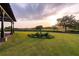 The grand entrance features beautiful landscaping and scenic golf course views at 4121 Golf Cottage Ln, Johns Island, SC 29455