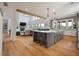 Open concept kitchen, living room and dining area with spacious island and hardwood floors at 4121 Golf Cottage Ln, Johns Island, SC 29455