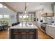 Bright kitchen boasts large island, stainless appliances, and views of lush landscaping at 4121 Golf Cottage Ln, Johns Island, SC 29455