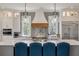 Bright kitchen features a large center island with seating, modern appliances, and a stylish backsplash at 4121 Golf Cottage Ln, Johns Island, SC 29455