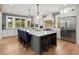 Bright kitchen features a large center island with seating, modern appliances, and backyard views at 4121 Golf Cottage Ln, Johns Island, SC 29455
