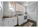 Well-organized laundry room with white cabinets, a sink, and modern appliances at 4121 Golf Cottage Ln, Johns Island, SC 29455