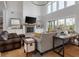 Inviting living room with vaulted ceilings, fireplace, and large windows at 4121 Golf Cottage Ln, Johns Island, SC 29455