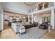 Open-concept living room features high ceilings, hardwood floors, and a seamless flow to the kitchen and dining areas at 4121 Golf Cottage Ln, Johns Island, SC 29455