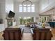 Grand living room with soaring ceilings, a cozy fireplace, expansive windows, and comfortable seating at 4121 Golf Cottage Ln, Johns Island, SC 29455
