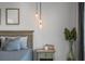 Main bedroom detail showcasing light fixtures, night stand, and a cozy decor at 4121 Golf Cottage Ln, Johns Island, SC 29455