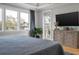 Main bedroom with large windows, tray ceilings, and a large flat screen TV at 4121 Golf Cottage Ln, Johns Island, SC 29455