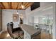 Bright home office boasting hardwood floors, brick accent wall, and an adjacent hallway at 4121 Golf Cottage Ln, Johns Island, SC 29455
