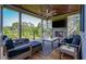 Relaxing screened porch with a fireplace, comfortable seating, a ceiling fan, and scenic views at 4121 Golf Cottage Ln, Johns Island, SC 29455