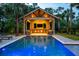 Outdoor pool with a poolside pavilion, featuring a bar area, outdoor seating, and a beautiful backyard at 4121 Golf Cottage Ln, Johns Island, SC 29455