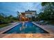 Inviting backyard pool area with in-water seating, lounge chairs, and a view of the home at 4121 Golf Cottage Ln, Johns Island, SC 29455