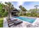 Gorgeous pool with a pavilion, lounge chairs, and tropical landscaping at 4121 Golf Cottage Ln, Johns Island, SC 29455
