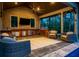 A well-appointed poolside pavilion with a brick exterior, ceiling fan, bar, outdoor seating and a grill at 4121 Golf Cottage Ln, Johns Island, SC 29455