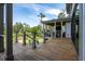 Spacious covered porch with a wood-burning fireplace and outdoor seating area overlooking a lush landscape at 4121 Golf Cottage Ln, Johns Island, SC 29455