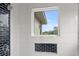 This shower has a window, white subway tile, and black tile as accents at 4121 Golf Cottage Ln, Johns Island, SC 29455