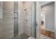 Contemporary shower with tile walls, built-in niche, and a glass door at 4121 Golf Cottage Ln, Johns Island, SC 29455