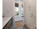 Bright bathroom with a glass-enclosed shower and view of the deck at 4121 Golf Cottage Ln, Johns Island, SC 29455